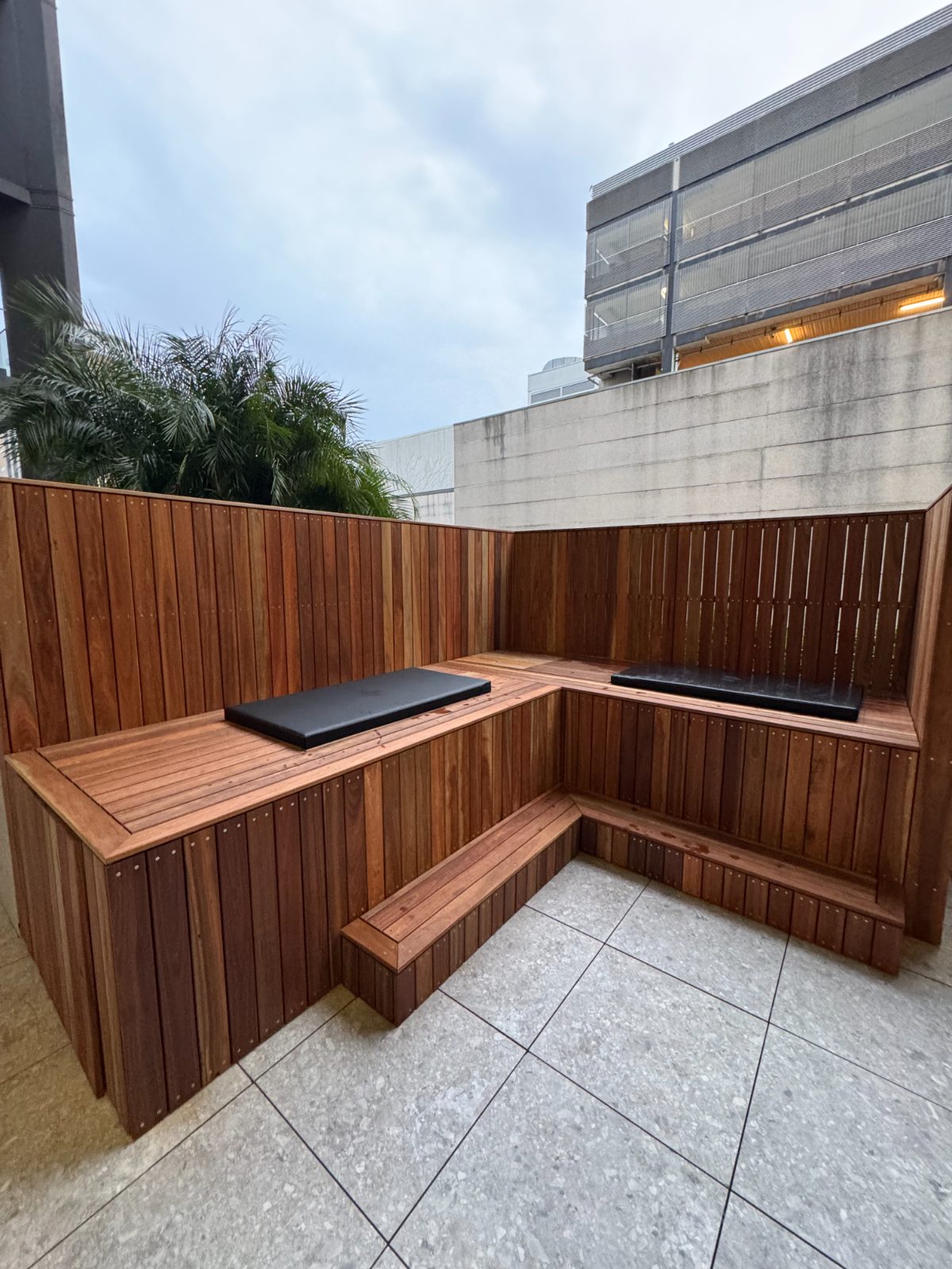 Outdoor timber-clad plunge and bench seating on a terrace